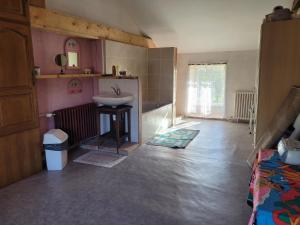 a bathroom with a sink in a room with a sink at Ferme fruitière zéro traitement in Ernée