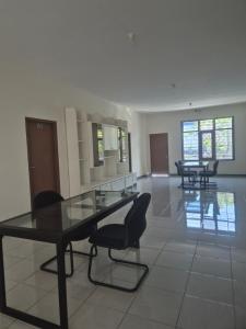 a dining room with a glass table and chairs at ERCA Yogyakarta in Yogyakarta