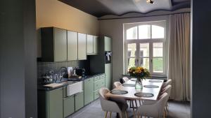 a kitchen with a table and chairs and a window at Hoeve Hazegras in Knokke-Heist