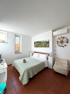 a bedroom with a bed with a striped bedspread at Bio&B Acquaviva in Otranto
