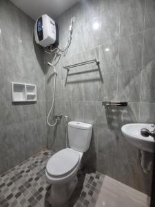 a bathroom with a toilet and a sink at ERCA Yogyakarta in Yogyakarta +110 photos