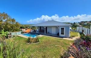 a house with a swimming pool in a yard at Villa Gommier - 3 chambres, 3 sdb, piscine in Le Diamant