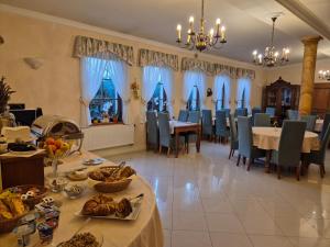 a dining room with tables and chairs with food on them at Hotel Nosal in Prague