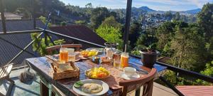 a table with food on top of a balcony at Redwood inn homestay in Nuwara Eliya