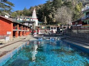 a large pool of water in the middle of a city at OmiHomeStay Dharamkot McLeodganj in Dharamshala