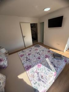 a bedroom with a large bed with a flowered rug at LUXURY Rooms Punat in Punat +26 photos