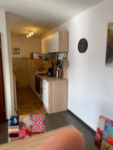 a small kitchen with white cabinets and a counter at Bungalow Orketal Sauerland in Medebach
