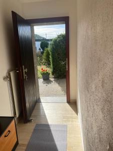 an open door with a view of a garden at Bungalow Orketal Sauerland in Medebach