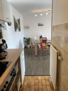 a kitchen with a table and a dining room at Bungalow Orketal Sauerland in Medebach +3 photos