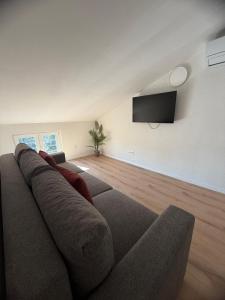 a living room with a couch and a flat screen tv at LUXURY Rooms Punat in Punat