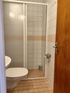 a bathroom with a shower with a toilet and a sink at Sun life room in Stockholm