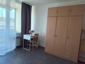 a room with a desk and a table with a cupboard at Sun life room in Stockholm