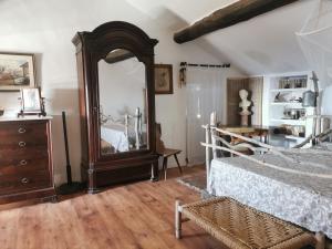 a bedroom with a bed and a large mirror at Chambre des rêves, vue exceptionnelle sur terrasse privée,la Casamatta in Centuri