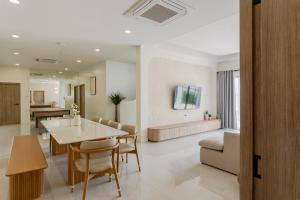 a dining room and living room with a table and chairs at Siwara poolvilla in Jomtien Beach