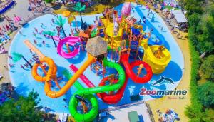 an aerial view of a water park with a roller coaster at CHouse Golf MarediRoma in Ardea