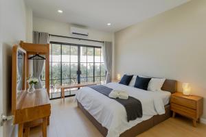 a bedroom with a large bed and a large window at Siwara poolvilla in Jomtien Beach +45 photos