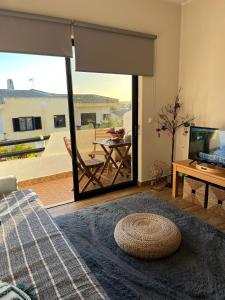 a living room with a large sliding glass door with a patio at Casa das Oliveirinhas in Alvor