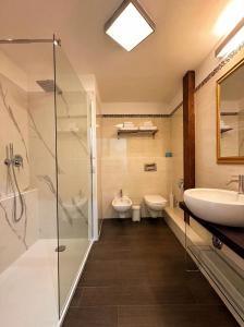 a bathroom with a sink and a shower and a toilet at Hotel Le Chevalier in Taormina +61 photos