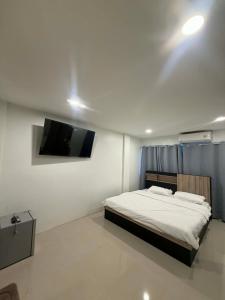a bedroom with a bed and a flat screen tv at The Sweet Escape in Ban Kathu (1) +4 photos