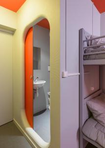 a bathroom with a mirror and a bunk bed at Centre International de Séjour André Wogenscky in Saint-Étienne