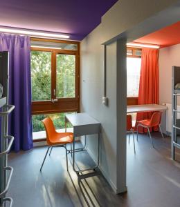 a room with a table and chairs and a window at Centre International de Séjour André Wogenscky in Saint-Étienne