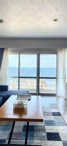 a living room with a laptop on a coffee table at Blu Mare in Ō-shima