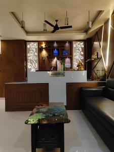 a living room with a couch and a table at Hotel Lake View in Port Blair