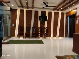 a dining room with chairs and a ceiling fan at Hotel Lake View in Port Blair