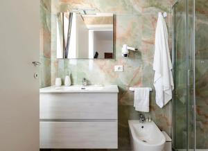 a bathroom with a sink and a mirror at Quintessenza- Luxury Suites in Leverano