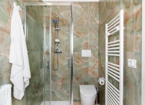a bathroom with a shower and a toilet at Quintessenza- Luxury Suites in Leverano