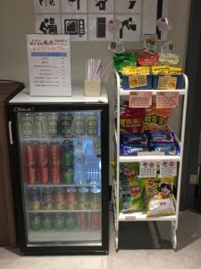 a refrigerator and a drink cooler in a store at Cavemen Hostel Taipei Station Youth Branch in Taipei