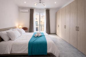 a bedroom with a bed with a teddy bear on it at Casa vacanza da Paola in Trapani