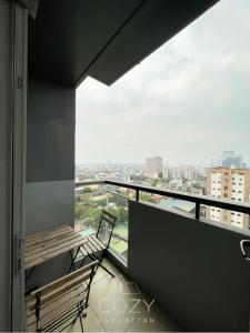 a balcony with a bench and a view of a city at Studio Unit in Manhattan Heights with Balcony in Sampong