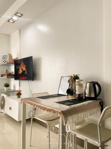 a table with a laptop computer on top of it at Studio Unit in Manhattan Heights with Balcony in Sampong
