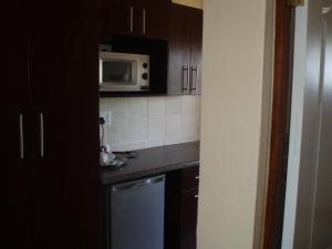 a kitchen with a sink and a microwave at Ocean View Villas C10 in Port Edward +4 photos
