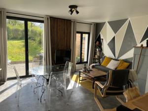 a living room with a glass table and a couch at Appartement RDC quartier calme in Saint-Dizier