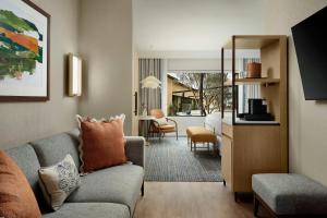 a living room with a couch and a table at Hotel Solea, Autograph Collection in Carlsbad