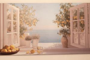 a painting of a window with a view of the ocean at La Cortese, cuore barocco in Noto