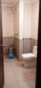 a bathroom with a toilet and a sink at Hotel Sitara Grand, KPHB in Hyderabad
