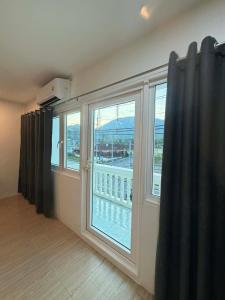 a room with a large window with a view at The Sweet Escape in Ban Kathu (1)