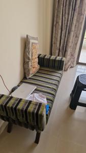 a couch with a laptop on it in a room at Anwesha's Home Stay Alibaug in Alibaug