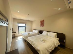 a bedroom with two beds with stuffed animals on them at Le VyN Mang Den in Kon Plong