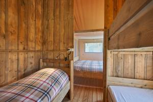 a bedroom with two beds in a wooden cabin at Village de Montmarsis in Gourdon +128 photos