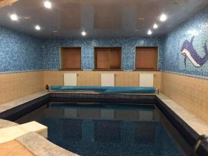 a swimming pool in a gymnasium with a pool at Ethno Complex Ukrayinske Selo in Buzovaya