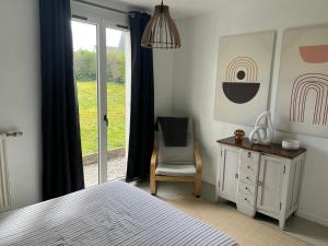 a bedroom with a bed and a chair and a window at Appartement RDC quartier calme in Saint-Dizier