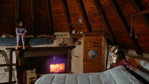 a girl sitting on a shelf in a room with a fireplace at Rifugio Ortobene in Nuoro