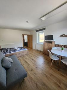 a living room with a couch and a table at Ferienwohnung Reich in Hirschegg Rein