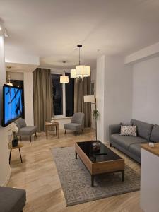a living room with a couch and a tv at Budva Central Escape Apartment in Budva