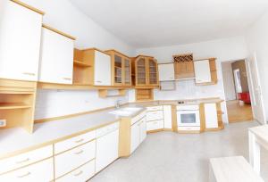 an empty kitchen with white cabinets and white appliances at Vacation, Work, Party in Allerstorf