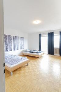 two beds in a room with blue curtains at Vacation, Work, Party in Allerstorf +2 photos